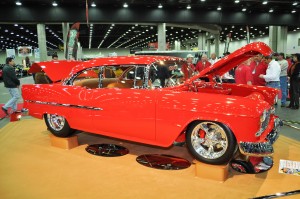 red 1955 chevy bel air custom on display at indoor car show