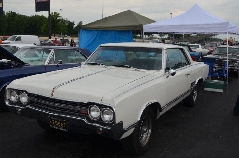 white Oldsmobile coupe f-85 cutlass at a car show