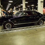 black Oldsmobile cutlass 442 at indoor car show