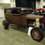 ford tudor hot rod coupe displayed at indoor car show