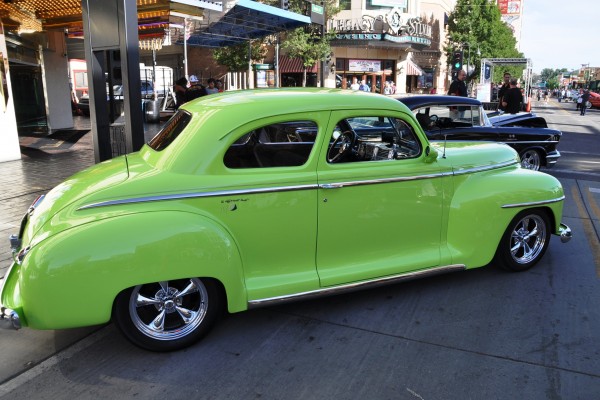 green custom prewar hot rod in a car show