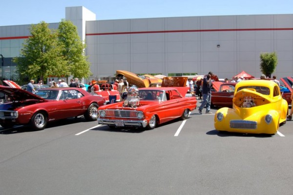 group of hot rods and muscle cars at a show