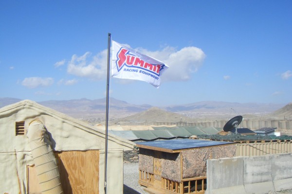 summit racing flag flying over military base in Afghanistan