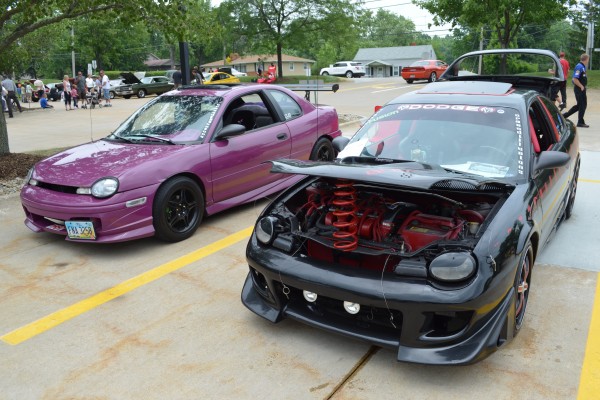 a pair of dodge neon sport compacts at car show