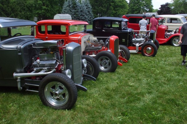 row of vintage hot rods at a classic car show