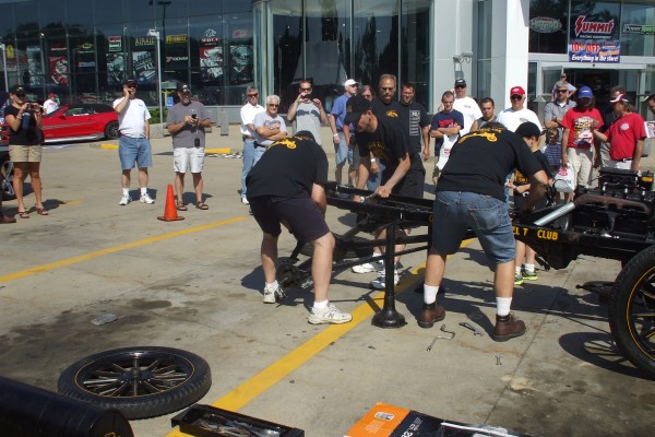 men assembling a ford model t demonstration, rear axle