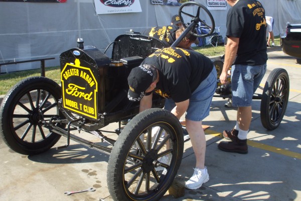 men assembling an antique ford model t during demonstration