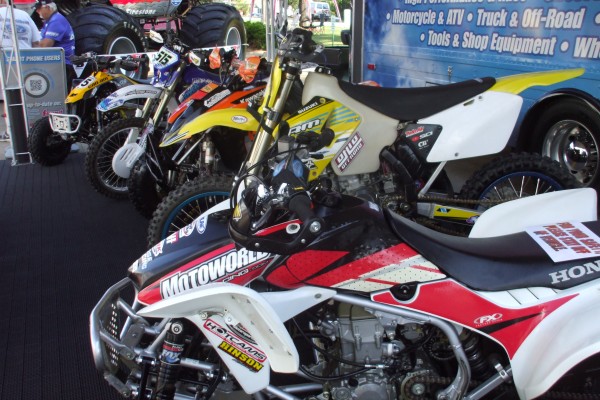 row of dirt bikes and atvs on display