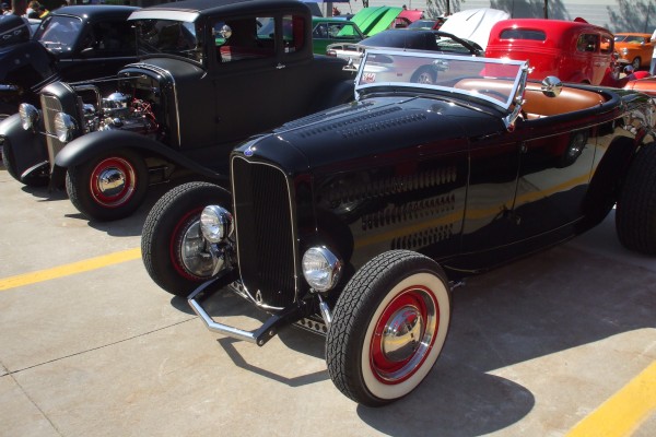 row of hot rods at a classic car show