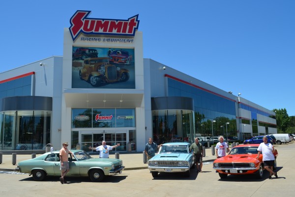 a classic car club parked in front of summit racing