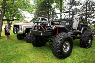 a lifted truck and jeep at a car show