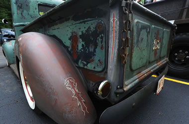 rear quarter view of an old ford truck tailgate and fender