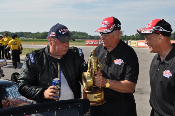 racer getting a nhra wally trophy