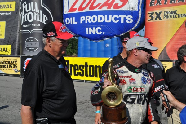 man with nhra wally trophy