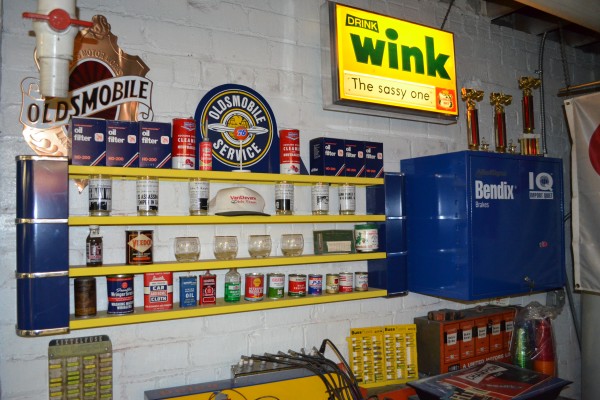 vintage oil cans and signs in car collection