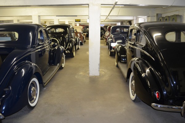 rows of antique cars stored in a museum collection