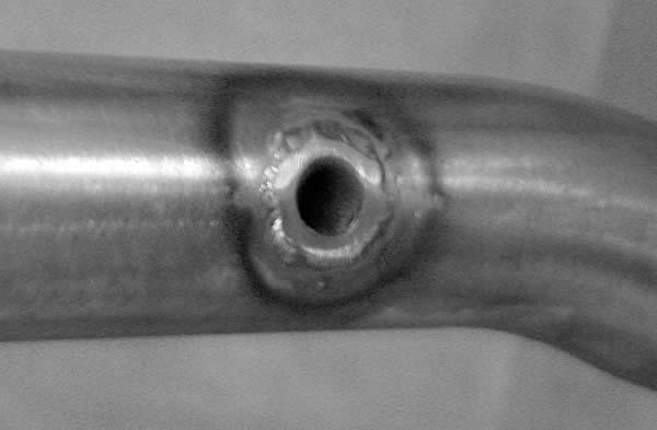 hole bung welded and drilled in a roll bar