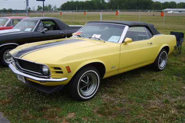 vintage first gen ford mustang convertible , yellow