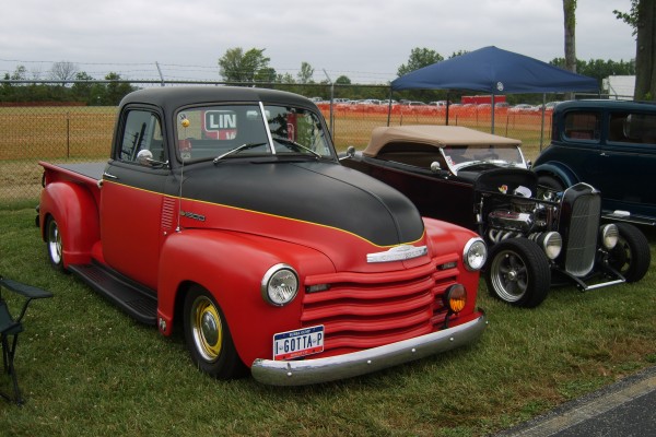 vintage truck and hot rod at a drag race show