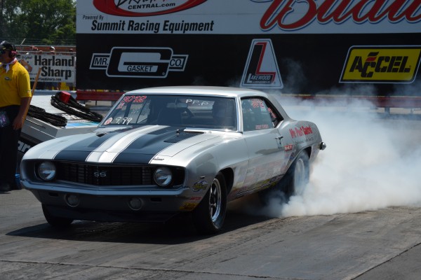 1969 chevy camaro drag car doing a burnout prior to a drag race