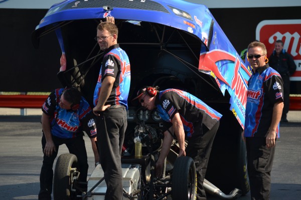 Crews working on Summit Racing NHRA Funny car prior to staging