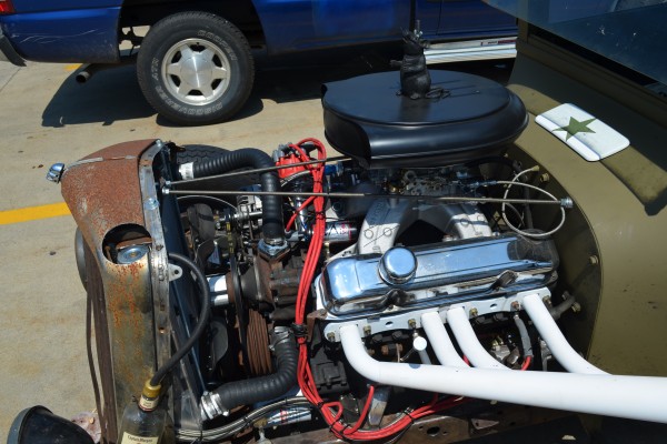 engine in a military themed ford rat rod tudor coupe