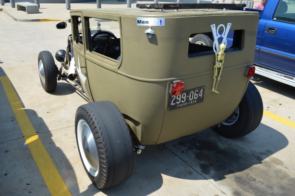 Rear view of a military themed ford rat rod tudor coupe
