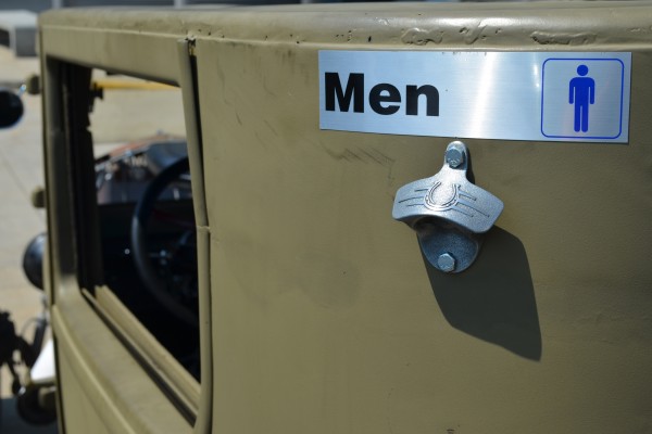 Men's room sign and beer bottle opener on a hot rod body