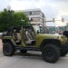 Green Jeep Wrangler Unlimited with doors removed thumbnail