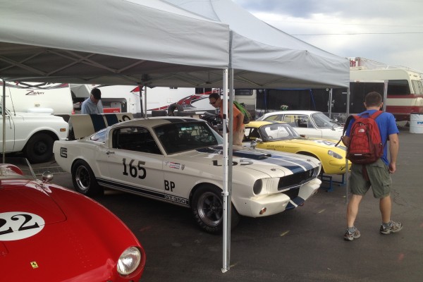vintage race cars under tent during Monterey Car Week, 2012