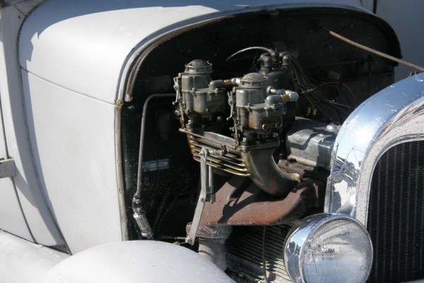vintage dual carb engine in a hot rod ford
