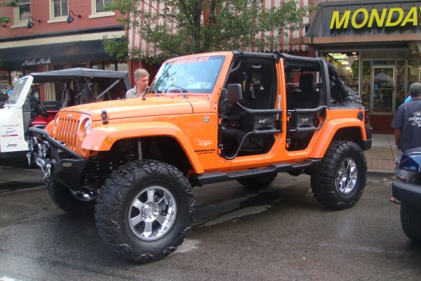 Orange Jeep Wrangler Unlimited with utility doors