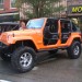 Orange Jeep Wrangler Unlimited with utility doors thumbnail