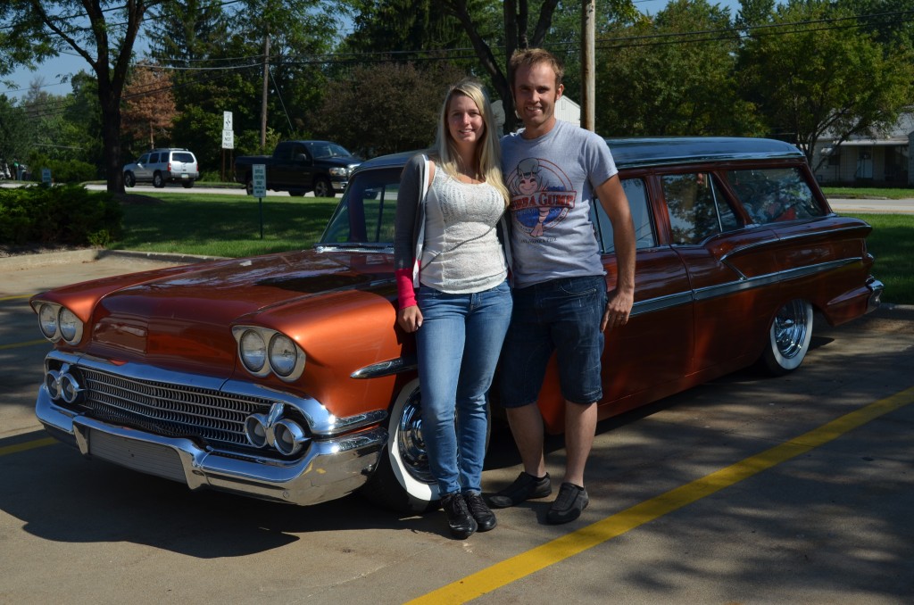 couple posing with vintage chevy station wagon