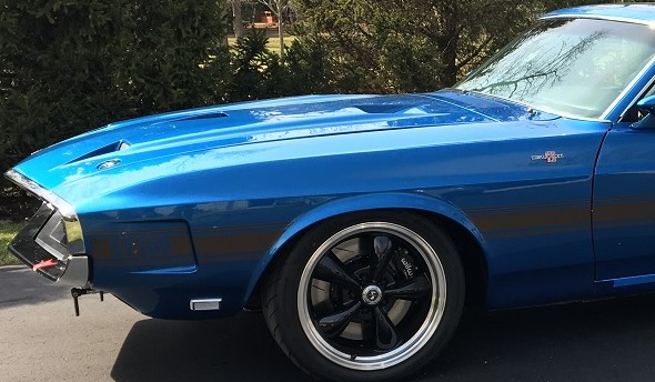 front of a musclecar with custom wheels