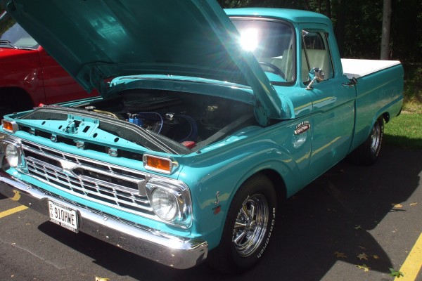 vintage blue ford f series truck at car show