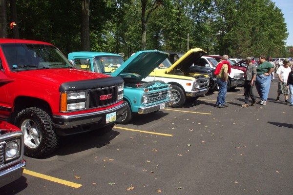 row of classic trucks at an old car show