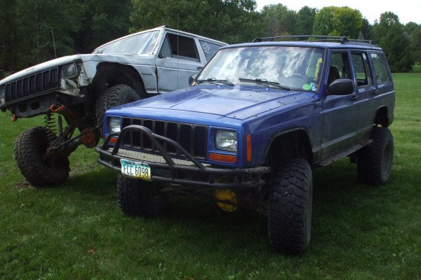 two jeep cherokee xj off roaders at a car show