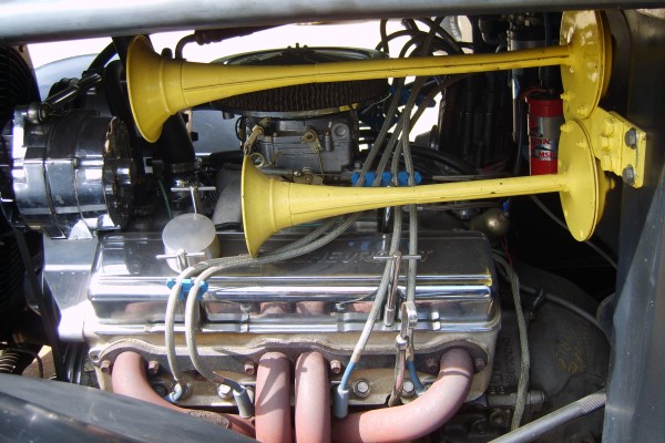 a pair of yellow train horns in a vintage hot rod truck