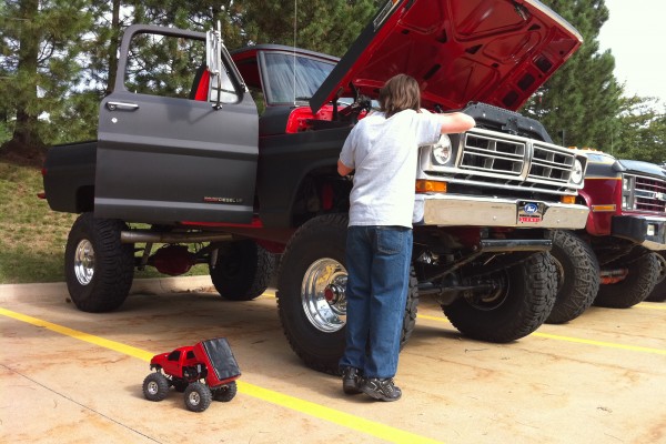 man looking at engine in a lifted ford truck