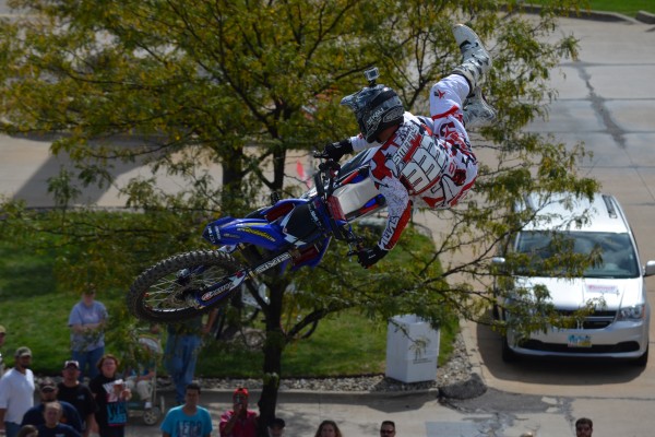 motocross rider doing aerial trick jump during dirt bike exhibition