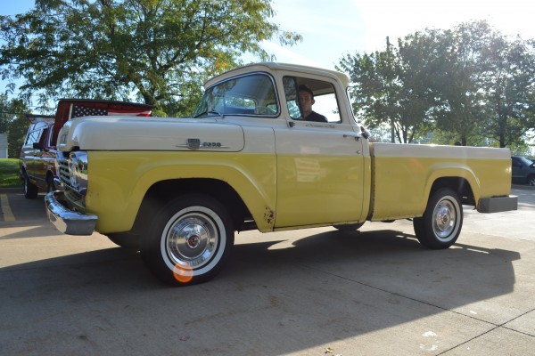 vintage ford pickup truck entering a car show