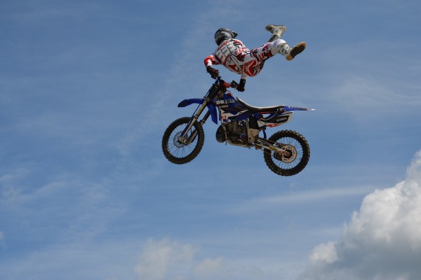 motocross rider in mid-jump during dirt bike exhibition