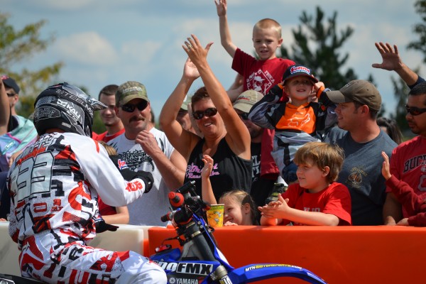 motocross rider greeting fans during dirt bike exhibition