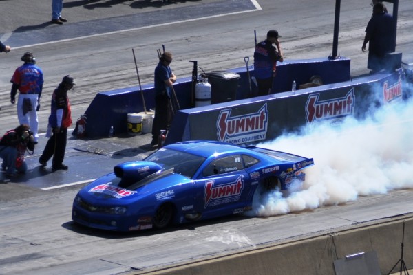 summit racing pro stock camaro doing a burnout prior to a DRAG RACE