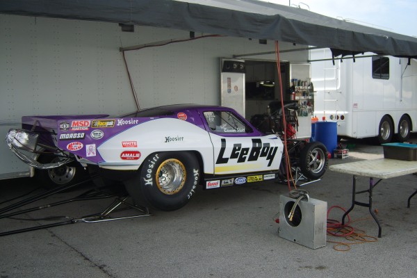 corvette dragster getting serviced in pits between races