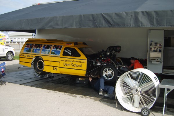 school bus drag race pro mod in pits during race