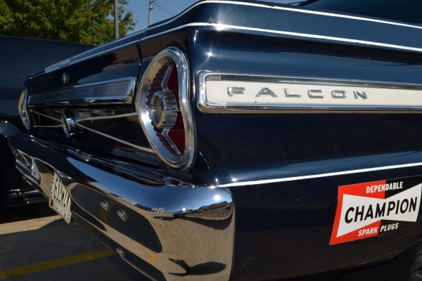 close up of rear fender emblem on flank of a 1965 Ford Falcon