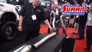 man showcasing mufflers and exhaust systems at trade show