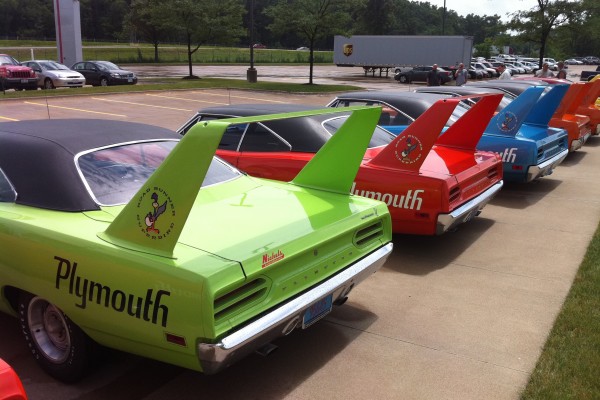 rear view of a row of plymouth superbird wings at classic car show